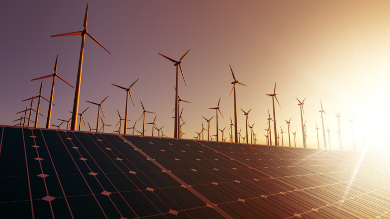 Zu sehen sind Windkraftanlagen und Solarmodule in der Abendsonne.